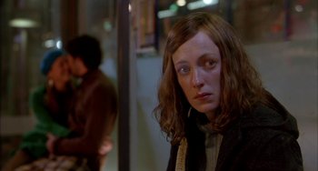 Movie still from “Eagle vs Shark” (2007), directed by Taika Waititi – A woman with long brown hair sitting in a room; Close Up shot, Over the shoulder angle