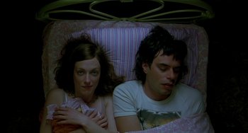 Movie still from “Eagle vs Shark” (2007), directed by Taika Waititi – A man and a woman laying in a bed together; Medium shot, Overhead angle