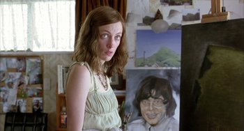 Movie still from “Eagle vs Shark” (2007), directed by Taika Waititi – A woman standing in front of a painting of a woman; Close Up shot, Over the shoulder angle