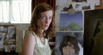 Movie still from “Eagle vs Shark” (2007), directed by Taika Waititi – A woman standing in front of a painting of herself; Close Up shot, Over the shoulder angle