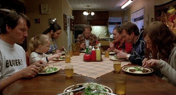 Movie still from “Eagle vs Shark” (2007), directed by Taika Waititi – A group of people sitting around a table eating food; Medium shot, High angle
