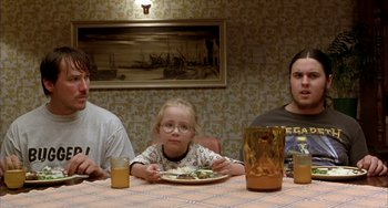 Movie still from “Eagle vs Shark” (2007), directed by Taika Waititi – A little girl sitting at a table with a plate of food; Medium shot, High angle