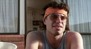 Movie still from “Eagle vs Shark” (2007), directed by Taika Waititi – A person wearing sunglasses and a bandana; Close Up shot, Low angle