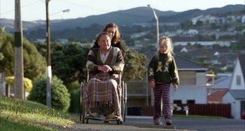 Movie still from “Eagle vs Shark” (2007), directed by Taika Waititi – An older man in a wheelchair with two young girls; Wide shot, Over the shoulder angle