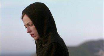 Movie still from “Eagle vs Shark” (2007), directed by Taika Waititi – A person wearing a hooded jacket is looking down; Close Up shot, Low angle