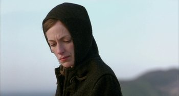 Movie still from “Eagle vs Shark” (2007), directed by Taika Waititi – A woman in a hooded jacket looking down; Close Up shot, Low angle