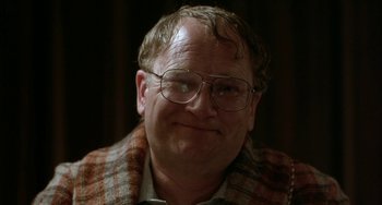 Movie still from “Eagle vs Shark” (2007), directed by Taika Waititi – An older man wearing glasses and a plaid jacket; Close Up shot, Low angle