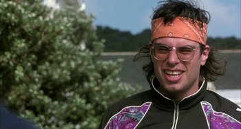 Movie still from “Eagle vs Shark” (2007), directed by Taika Waititi – A man with a bandana on his head and glasses; Close Up shot, Low angle