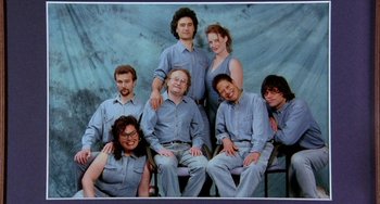 Movie still from “Eagle vs Shark” (2007), directed by Taika Waititi – A group of men and women posing for a picture; Wide shot, High angle