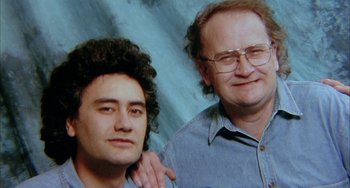 Movie still from “Eagle vs Shark” (2007), directed by Taika Waititi – A man and a woman pose for a picture; Close Up shot, High angle