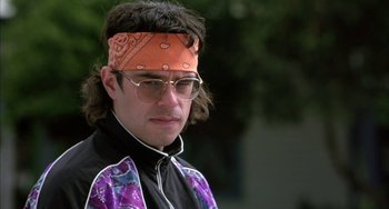 Movie still from “Eagle vs Shark” (2007), directed by Taika Waititi – A man with a bandanna on his head and glasses; Close Up shot, Low angle