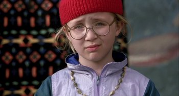 Movie still from “Eagle vs Shark” (2007), directed by Taika Waititi – A young girl wearing glasses and a red hat; Close Up shot, High angle
