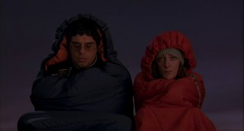Movie still from “Eagle vs Shark” (2007), directed by Taika Waititi – A man and a woman wrapped in a sleeping bag; Medium shot, Overhead angle