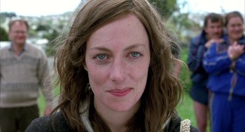 Movie still from “Eagle vs Shark” (2007), directed by Taika Waititi – A woman's face in a park; Close Up shot, Low angle