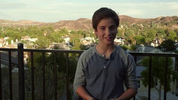 Movie still from “Earth to Echo” (2014), directed by Dave Green – A young boy standing on top of a balcony; Medium shot, High angle