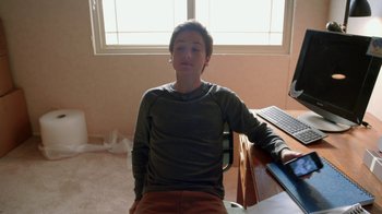 Movie still from “Earth to Echo” (2014), directed by Dave Green – A young man sitting at a computer desk in front of a computer; Medium shot, High angle