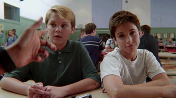 Movie still from “Earth to Echo” (2014), directed by Dave Green – Two young men sitting at a table in a classroom; Close Up shot, Over the shoulder angle
