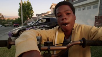 Movie still from “Earth to Echo” (2014), directed by Dave Green – A young man sitting on top of a bicycle; Close Up shot, Low angle