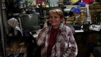 Movie still from “Earth to Echo” (2014), directed by Dave Green – A young man is talking on a cell phone; Medium shot, High angle