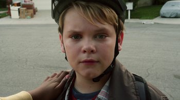 Movie still from “Earth to Echo” (2014), directed by Dave Green – A young boy wearing a bicycle helmet and a jacket; Close Up shot, High angle