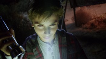 Movie still from “Earth to Echo” (2014), directed by Dave Green – A young boy is looking into the camera; Close Up shot, High angle