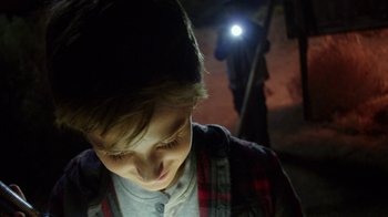 Movie still from “Earth to Echo” (2014), directed by Dave Green – A young boy is looking down at his face; Close Up shot, Low angle