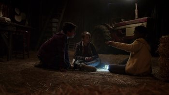 Movie still from “Earth to Echo” (2014), directed by Dave Green – A group of people sitting on the ground in the dark; Wide shot, High angle