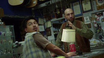 Movie still from “Earth to Echo” (2014), directed by Dave Green – Two men are standing at a counter in a store; Medium shot, Over the shoulder angle
