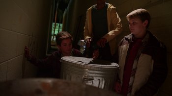 Movie still from “Earth to Echo” (2014), directed by Dave Green – A group of young people standing around a metal container; Medium shot, High angle