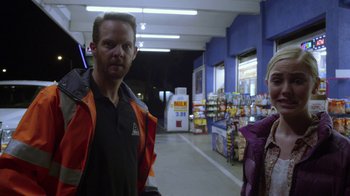 Movie still from “Earth to Echo” (2014), directed by Dave Green – A man and a woman standing in an aisle of a grocery store; Medium shot, Over the shoulder angle