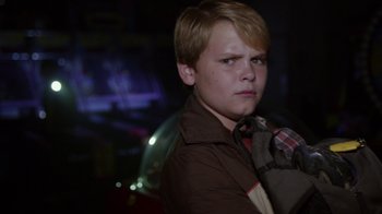 Movie still from “Earth to Echo” (2014), directed by Dave Green – A young boy wearing a brown jacket and a red tie; Close Up shot, Over the shoulder angle