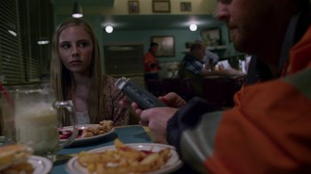 Movie still from “Earth to Echo” (2014), directed by Dave Green – A man and a woman sitting in front of a plate of food; Close Up shot, Over the shoulder angle