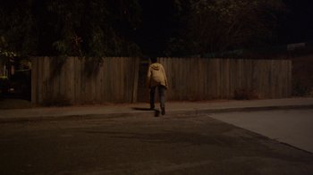 Movie still from “Earth to Echo” (2014), directed by Dave Green – A person walking down a street at night; Wide shot, High angle