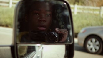 Movie still from “Earth to Echo” (2014), directed by Dave Green – A man taking a picture in the side mirror of a car; Close Up shot, Over the shoulder angle