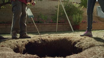 Movie still from “Earth to Echo” (2014), directed by Dave Green – A man standing over a hole in the ground; Wide shot, High angle