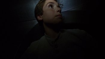Movie still from “Earth to Echo” (2014), directed by Dave Green – A young man looking up into the dark; Close Up shot, Overhead angle