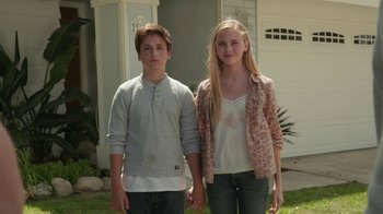 Movie still from “Earth to Echo” (2014), directed by Dave Green – A boy and a girl standing next to each other in front of a house; Medium shot, Low angle