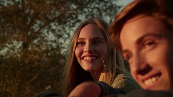 Movie still from “Earth to Echo” (2014), directed by Dave Green – A person smiling with trees in the background; Close Up shot, Over the shoulder angle