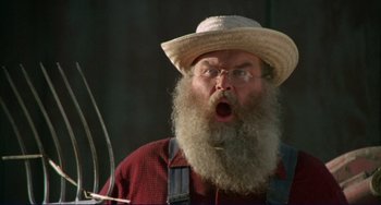 Movie still from “Eat My Dust” (1976), directed by Charles B. Griffith – An old man with a beard and a hat; Close Up shot, Low angle