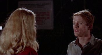 Movie still from “Eat My Dust” (1976), directed by Charles B. Griffith – A man and a woman talking to each other; Close Up shot, Over the shoulder angle