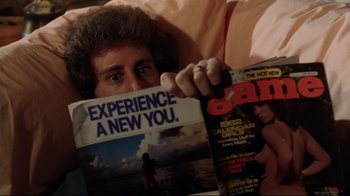 Movie still from “Eating Raoul” (1982), directed by Paul Bartel – A person holding a magazine in their hands; Extreme Close Up shot, Overhead angle