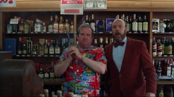 Movie still from “Eating Raoul” (1982), directed by Paul Bartel – Two men standing next to each other in front of bottles of alcohol; Medium shot, Low angle