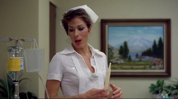 Movie still from “Eating Raoul” (1982), directed by Paul Bartel – A woman in a nurse's uniform holding a wooden stick; Medium shot, Low angle