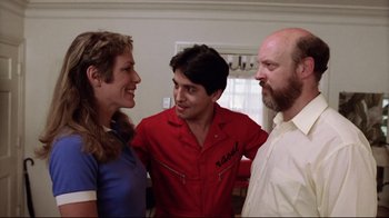 Movie still from “Eating Raoul” (1982), directed by Paul Bartel – Two men and a woman standing next to each other in a room; Medium shot, Low angle