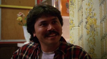 Movie still from “Eating Raoul” (1982), directed by Paul Bartel – A person wearing a plaid shirt; Close Up shot, Low angle