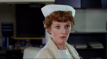 Movie still from “Eating Raoul” (1982), directed by Paul Bartel – A person wearing a nurse's hat; Close Up shot, Low angle