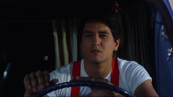 Movie still from “Eating Raoul” (1982), directed by Paul Bartel – A man in white shirt holding a steering wheel; Close Up shot, Low angle