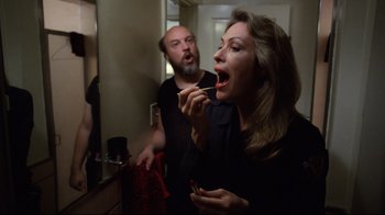 Movie still from “Eating Raoul” (1982), directed by Paul Bartel – A man and a woman brushing their teeth in front of a bathroom mirror; Medium shot, Over the shoulder angle