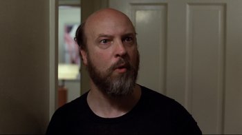 Movie still from “Eating Raoul” (1982), directed by Paul Bartel – A bald man with a beard and a mustache; Close Up shot, Low angle