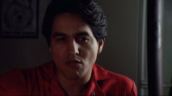 Movie still from “Eating Raoul” (1982), directed by Paul Bartel – A person wearing a red shirt; Close Up shot, Low angle